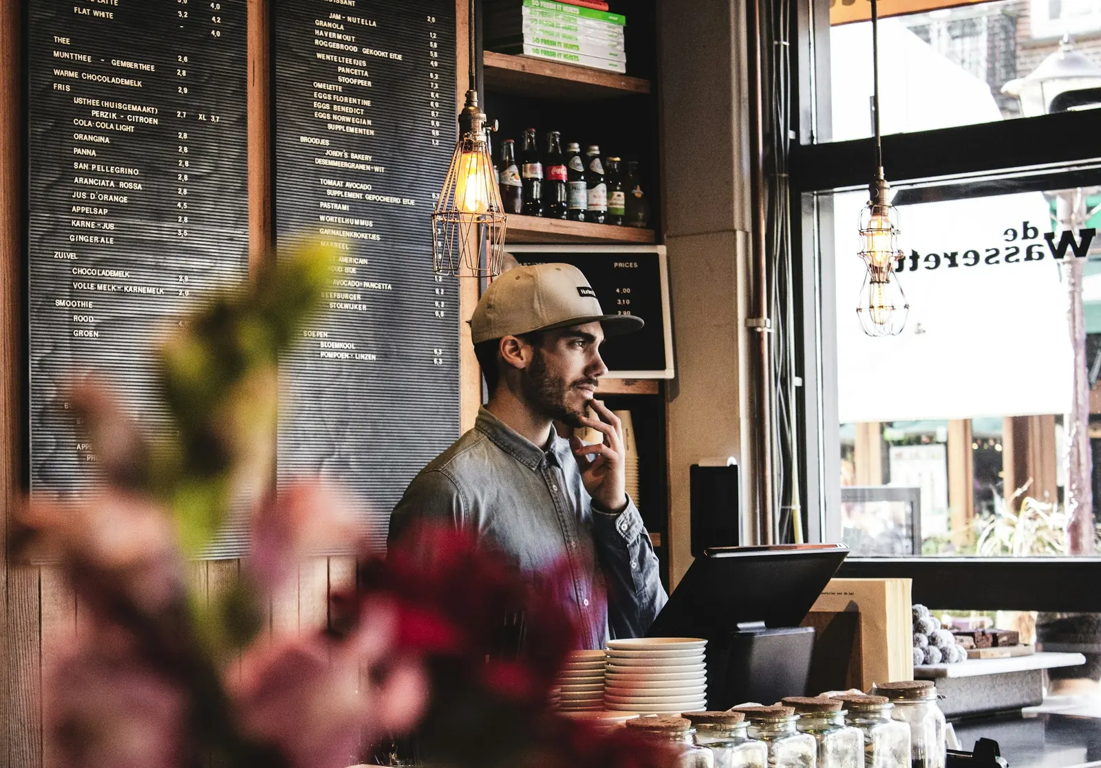 Café owner on the phone behind the counter
