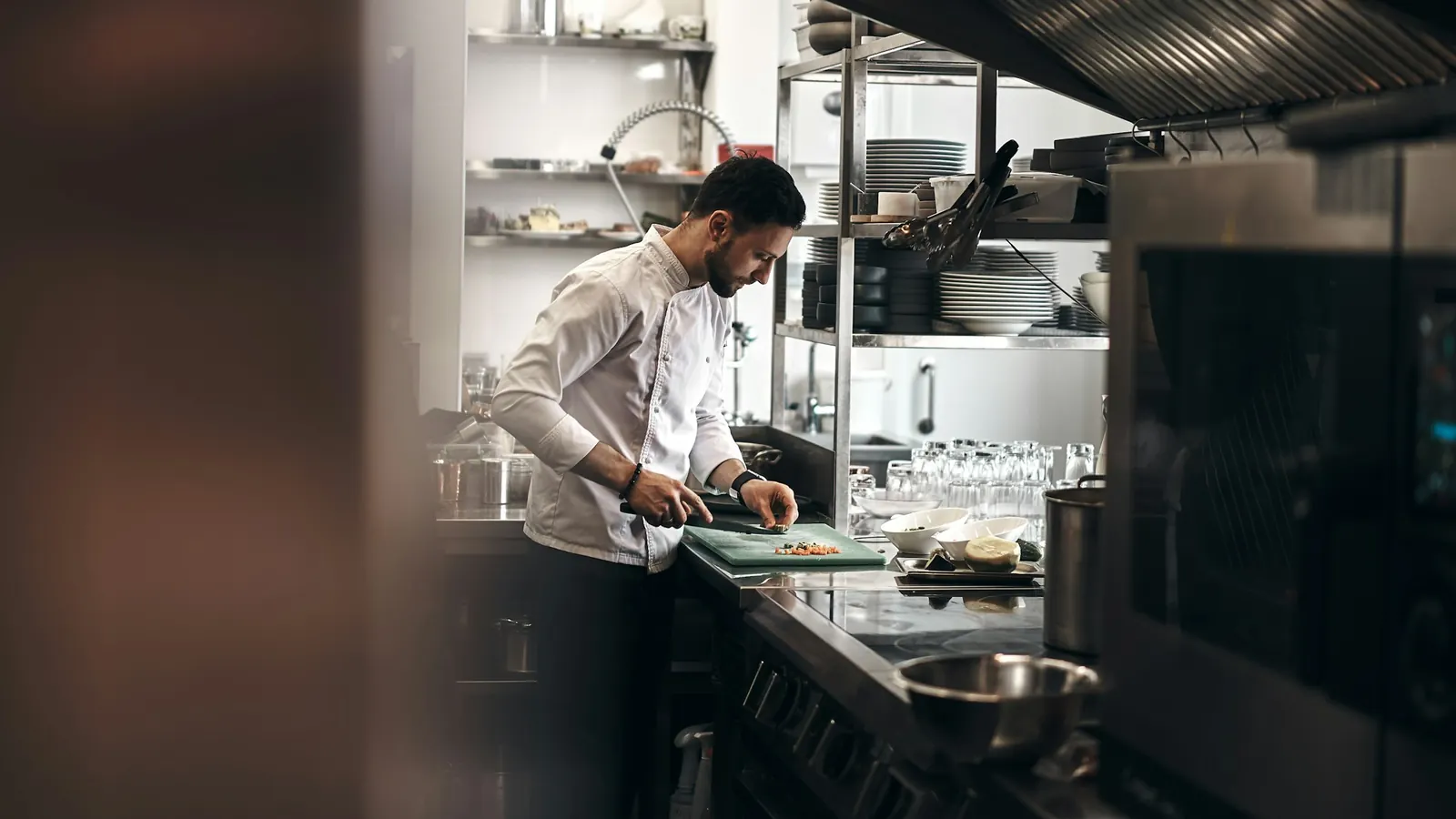 Chef preparing vegetables in a restaurant kitchen